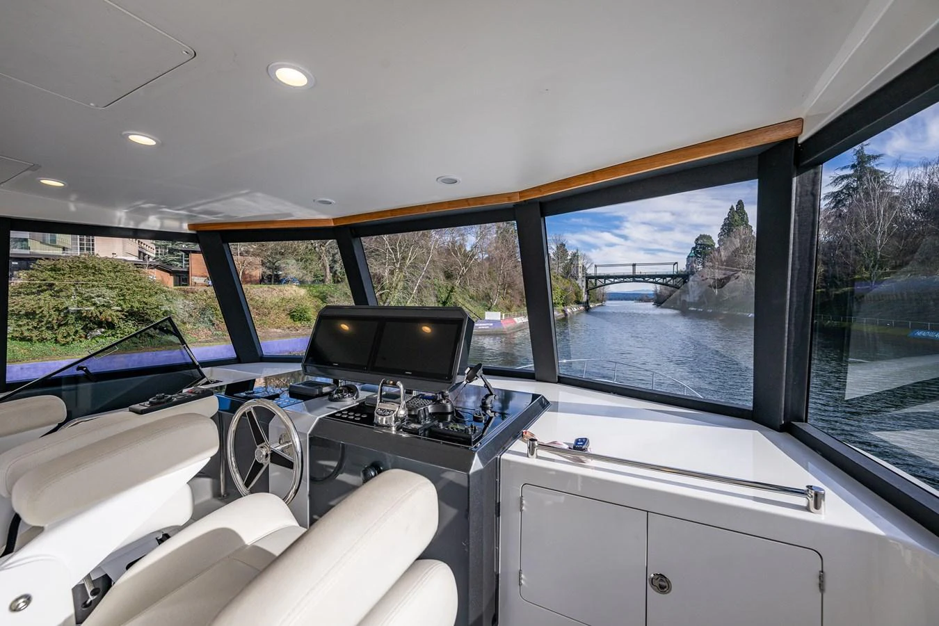 The helm station offers a panoramic view of the surrounding waters and landscape. aboard ISLAND BREEZE Yacht for Sale