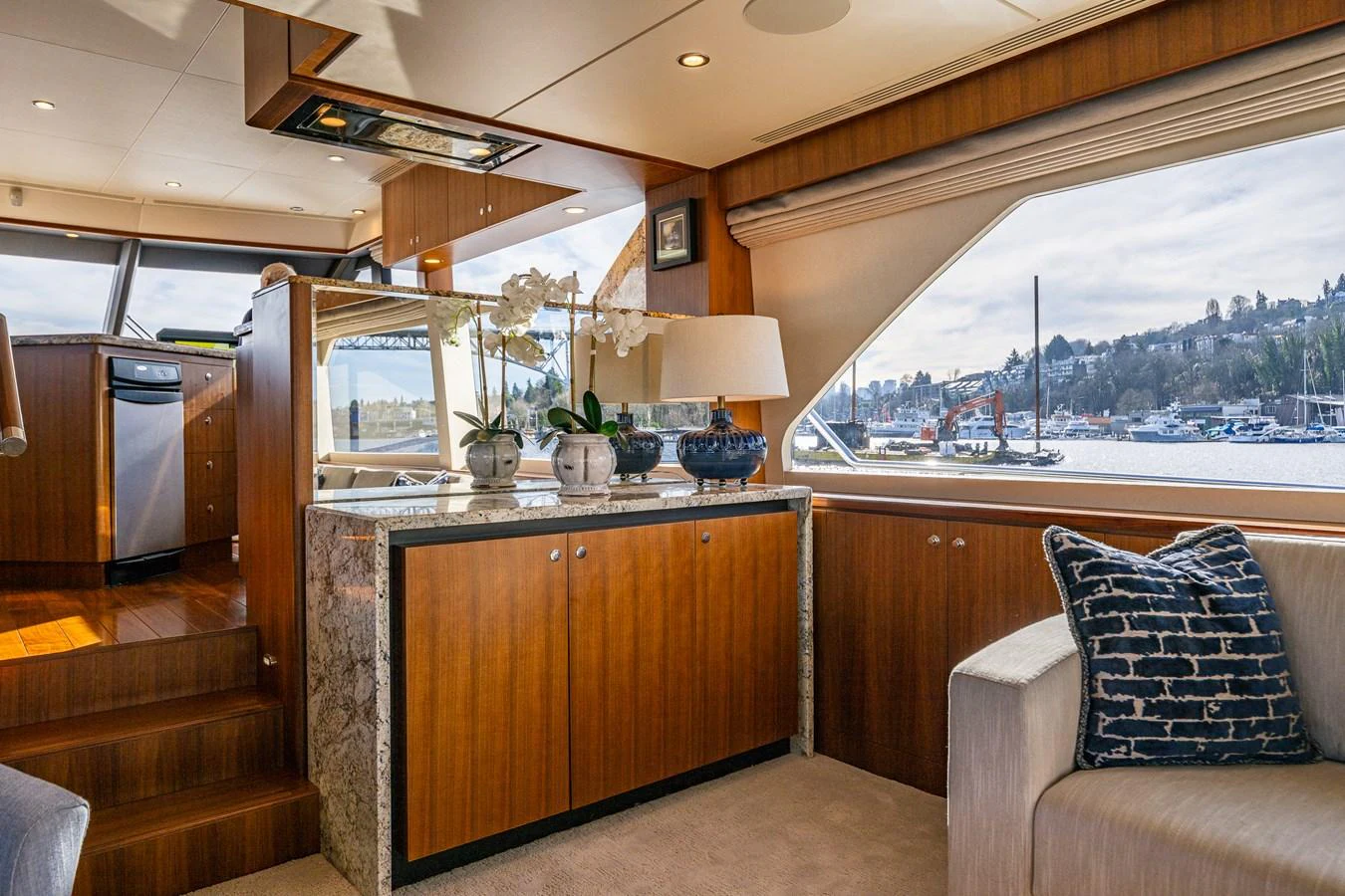 The yacht's interior features a cozy and elegant living area with a view of the marina. aboard ISLAND BREEZE Yacht for Sale