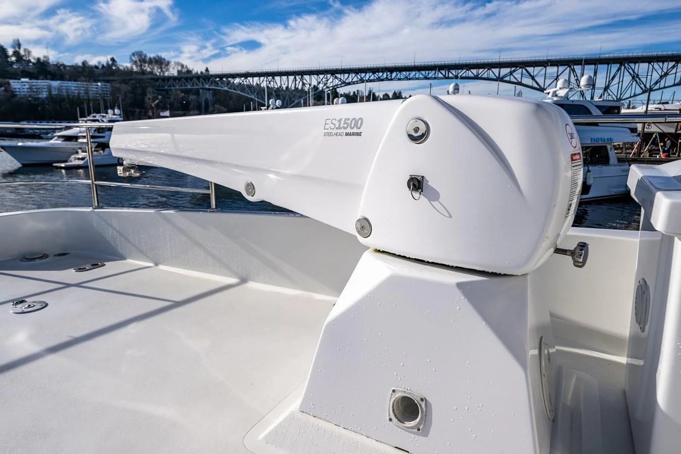 The image showcases a detailed view of a yacht's davit system against a marina backdrop. aboard ISLAND BREEZE Yacht for Sale