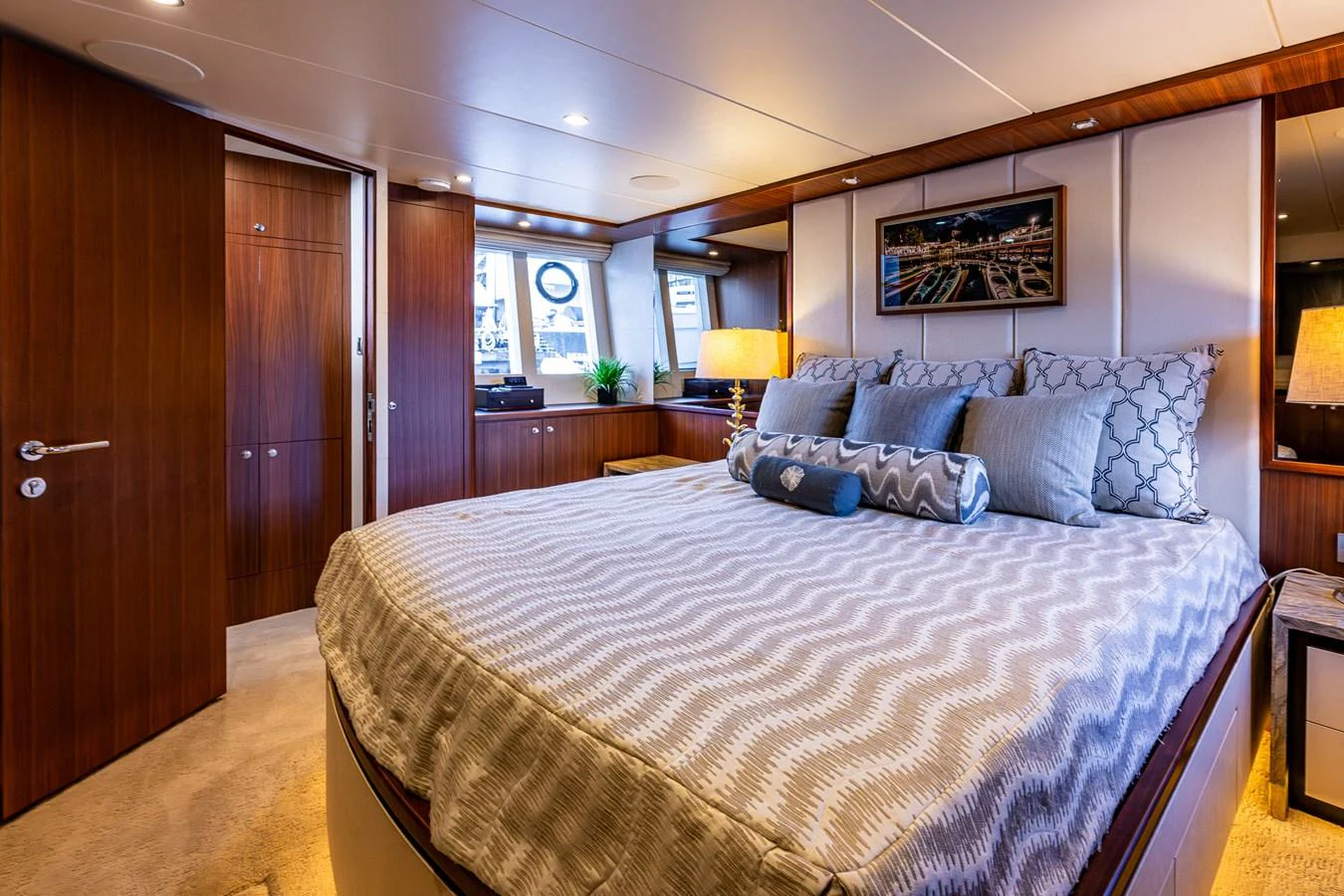 The master stateroom features a luxurious bed with elegant bedding and warm wood accents. aboard ISLAND BREEZE Yacht for Sale