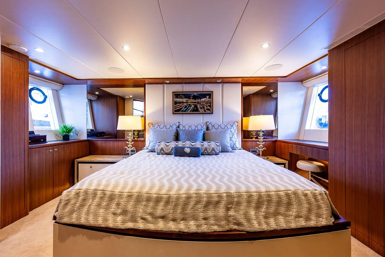 The master stateroom features a spacious bed with elegant decor and ample natural light. aboard ISLAND BREEZE Yacht for Sale