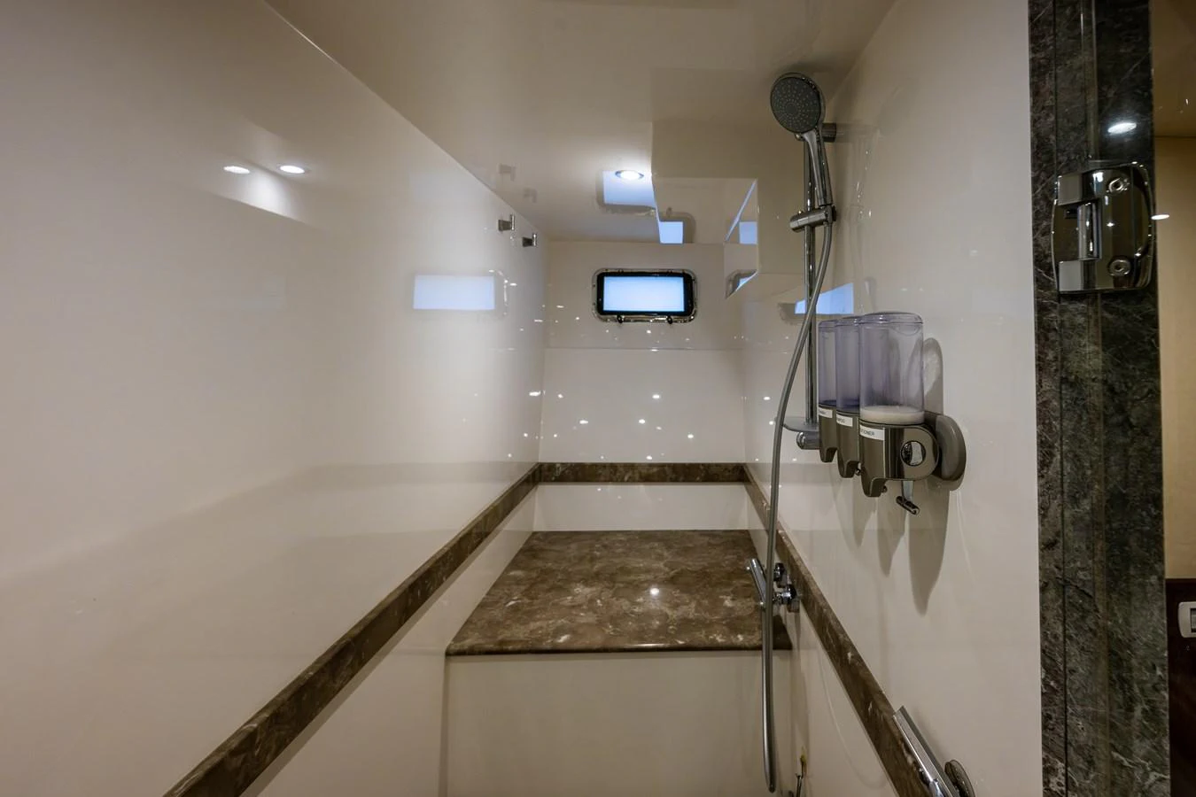 The yacht's bathroom features a sleek design with a modern shower and elegant marble accents. aboard ISLAND BREEZE Yacht for Sale