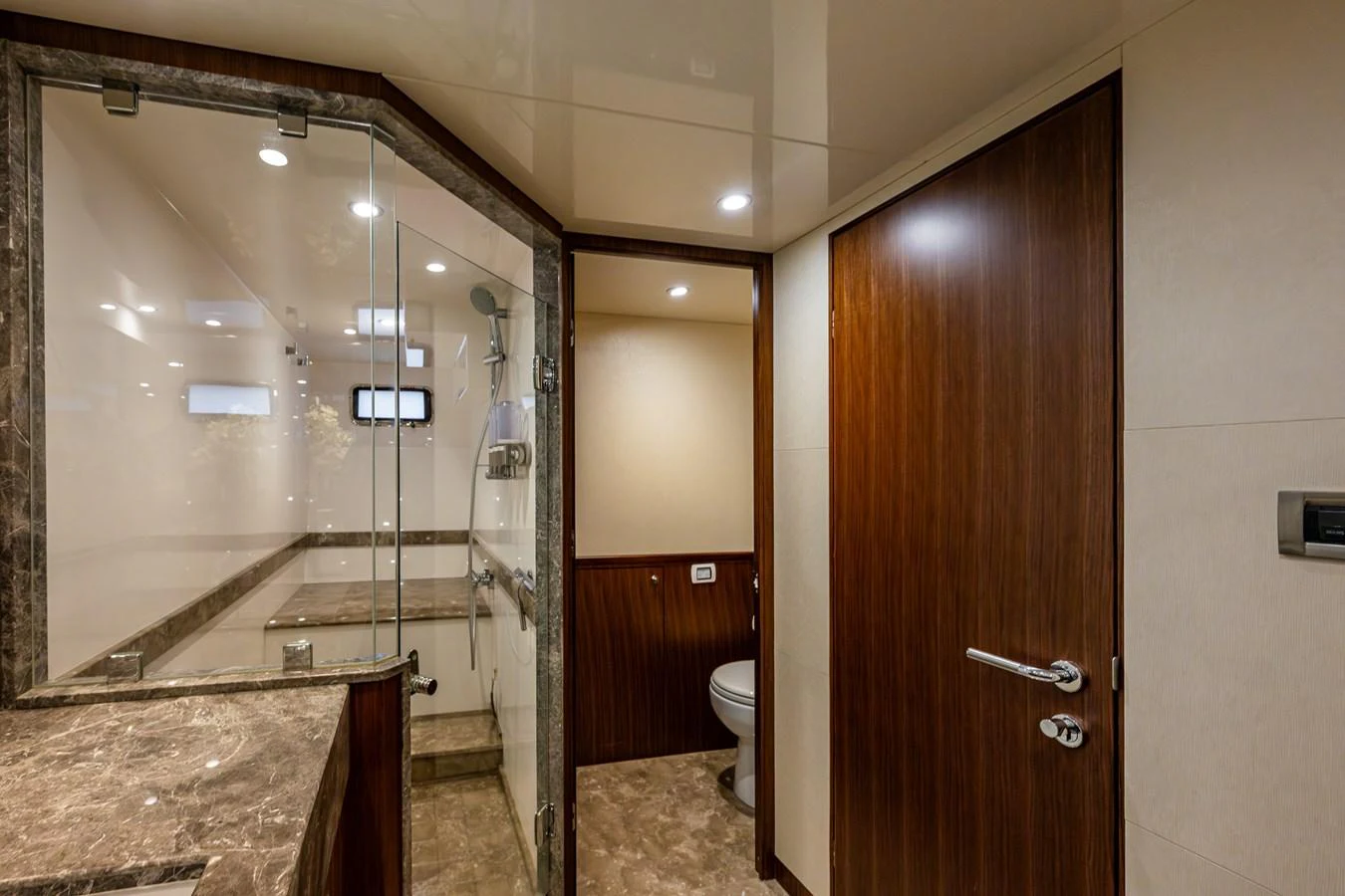 The yacht's bathroom features luxurious marble countertops and a spacious glass-enclosed shower. aboard ISLAND BREEZE Yacht for Sale