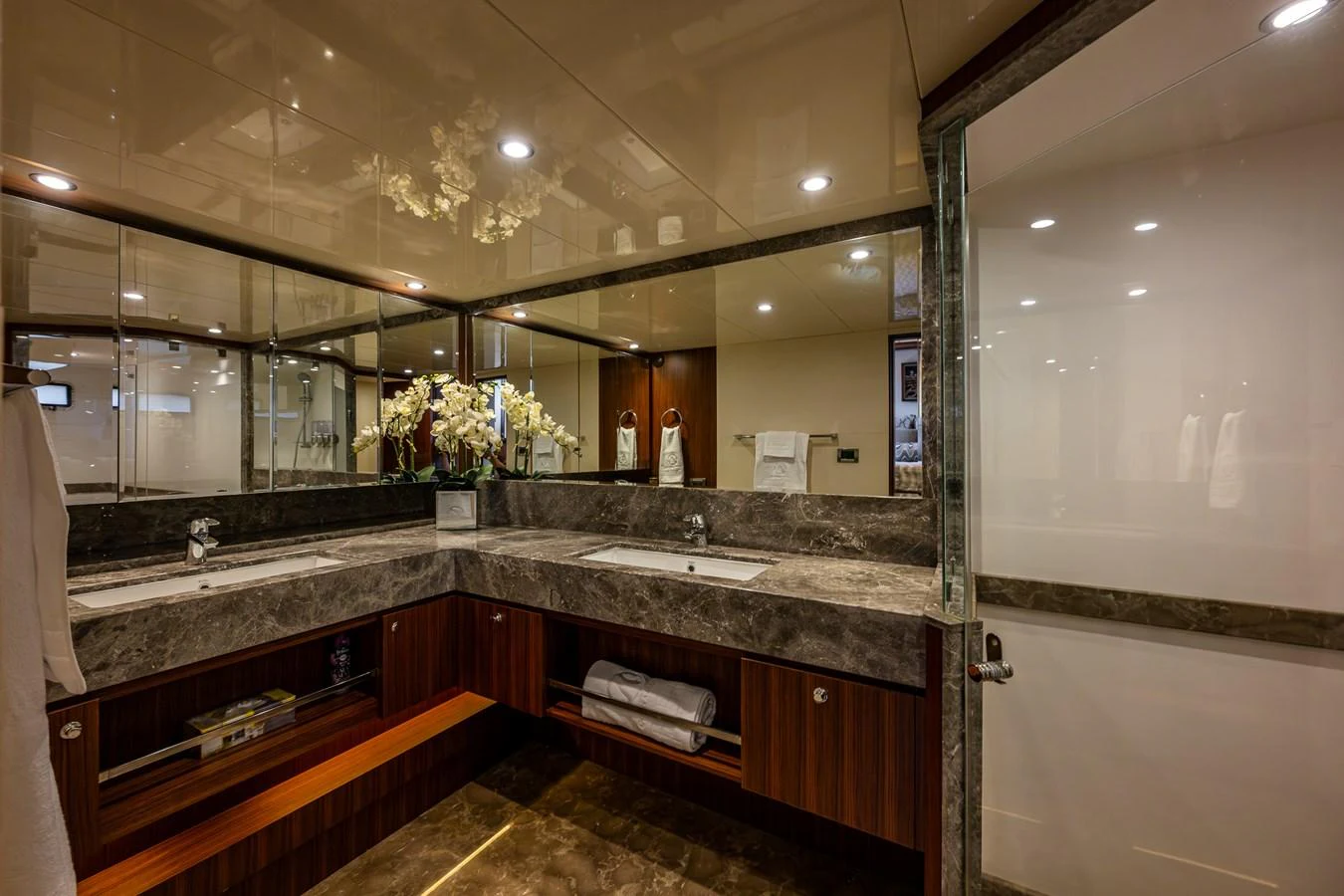 The yacht's bathroom features a luxurious double sink vanity with elegant marble countertops and modern fixtures. aboard ISLAND BREEZE Yacht for Sale