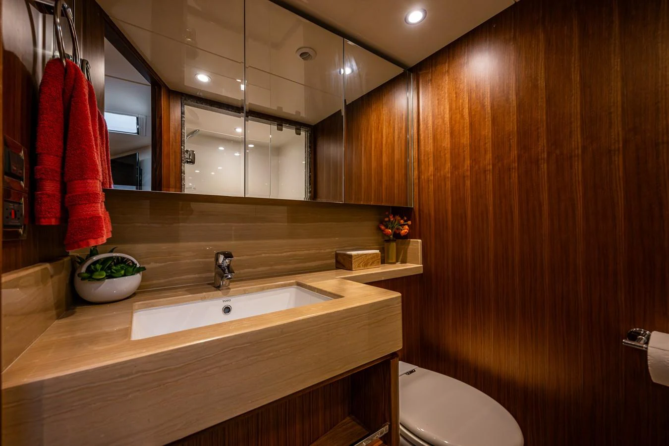 The yacht's bathroom features elegant wood paneling and modern fixtures, creating a warm and inviting atmosphere. aboard ISLAND BREEZE Yacht for Sale