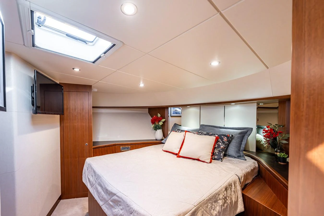 The stateroom features a cozy bed with elegant bedding and tasteful decor. aboard ISLAND BREEZE Yacht for Sale