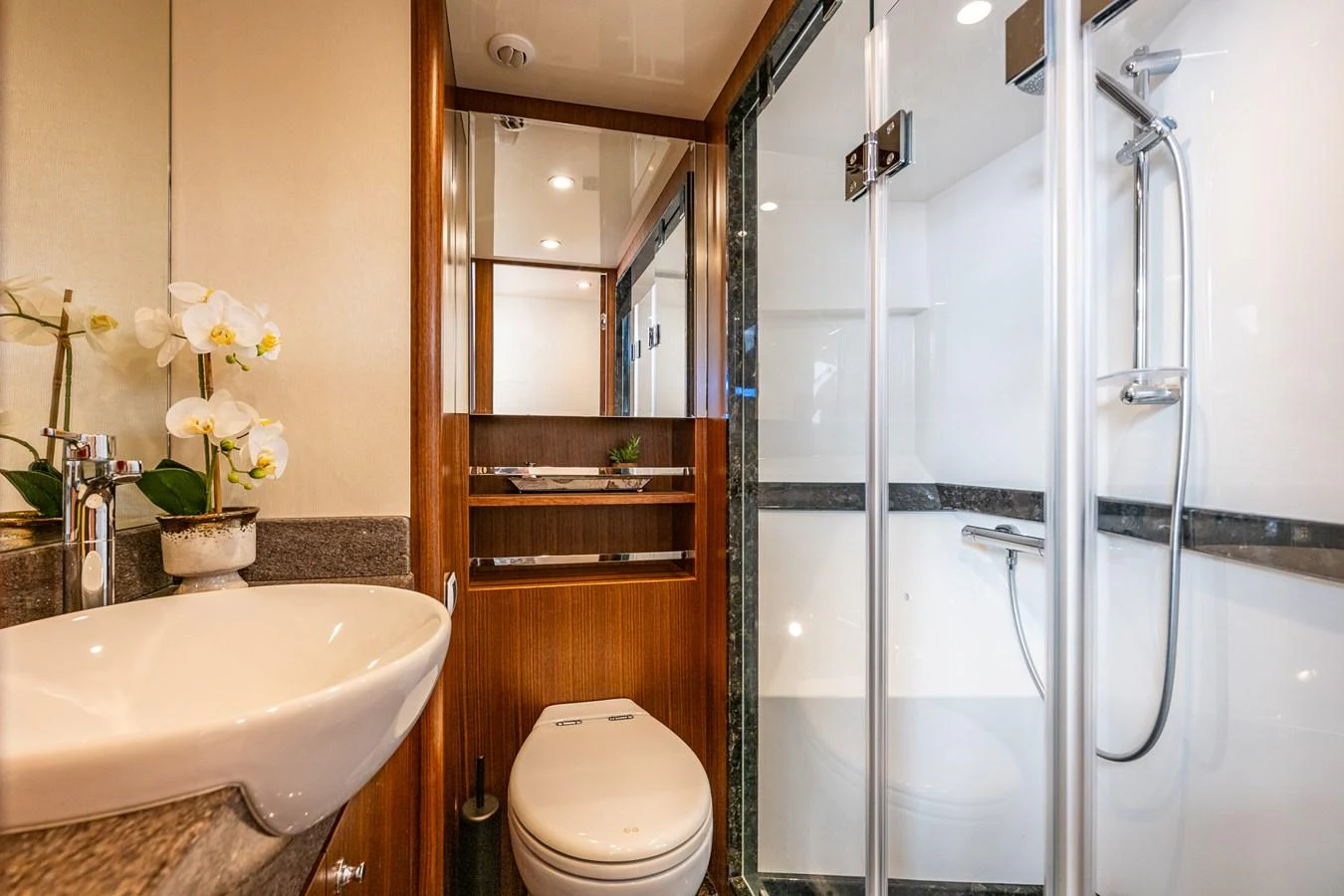 The yacht's bathroom features a modern design with a sleek shower and elegant fixtures. aboard ISLAND BREEZE Yacht for Sale