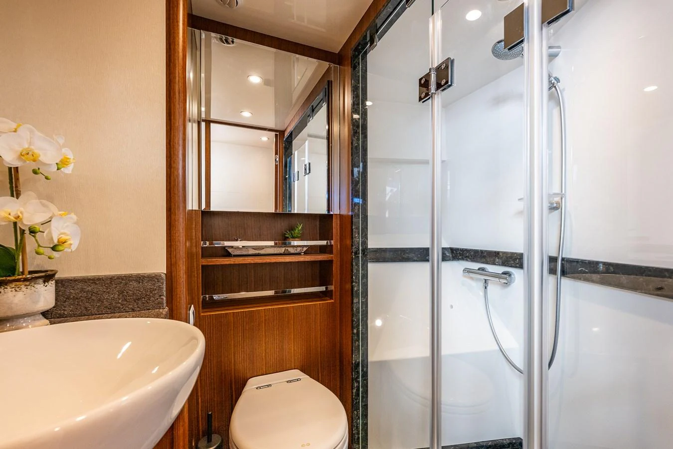 The yacht's bathroom features a modern shower, elegant sink, and stylish wooden accents. aboard ISLAND BREEZE Yacht for Sale