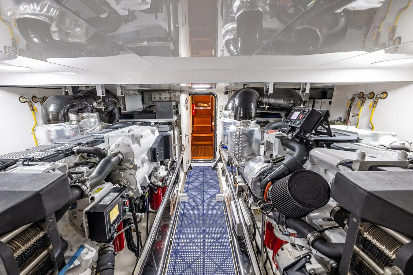 The engine room is meticulously organized, showcasing advanced machinery and clean installations. aboard ISLAND BREEZE Yacht for Sale
