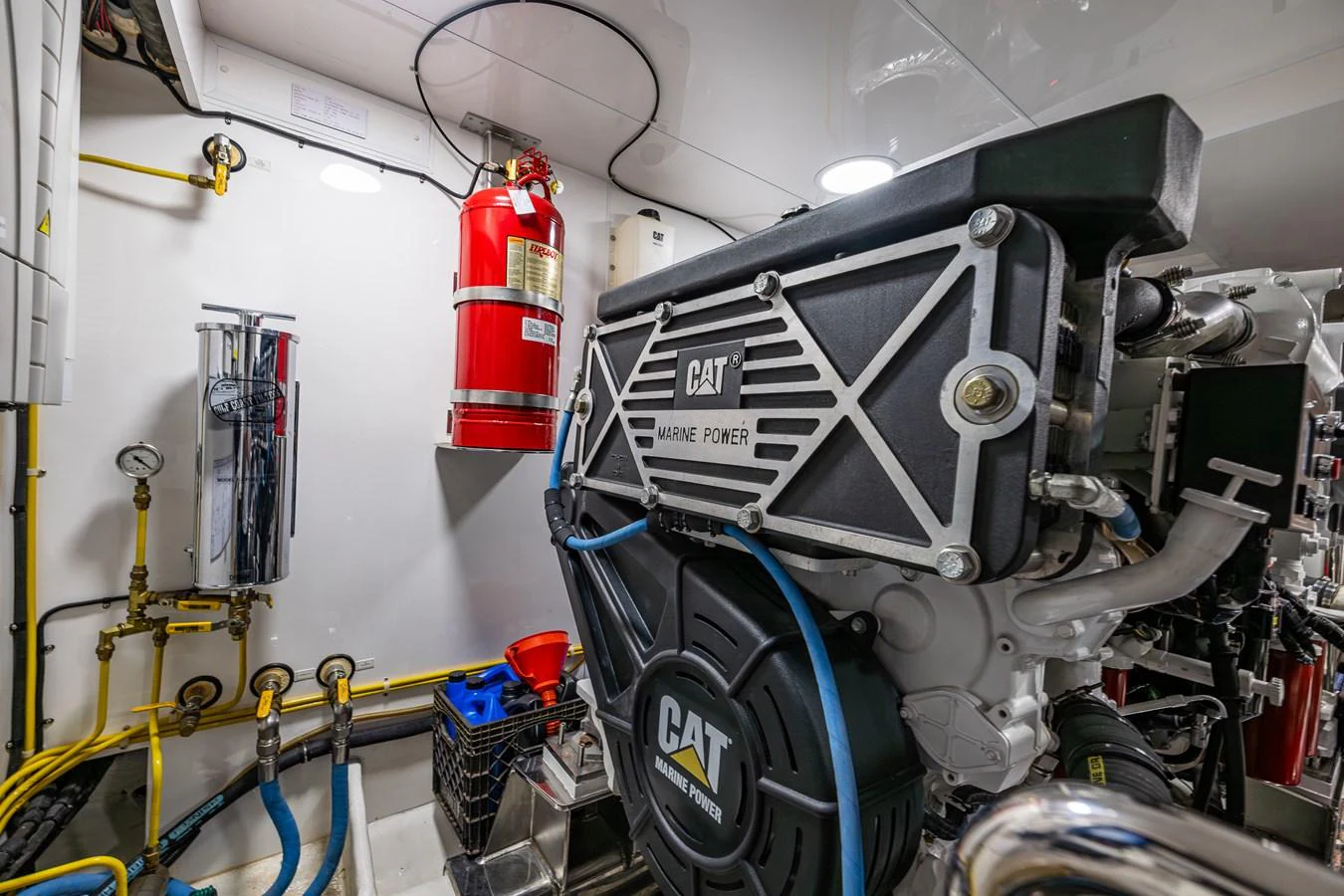 The image showcases a well-maintained engine room featuring a powerful CAT marine engine. aboard ISLAND BREEZE Yacht for Sale