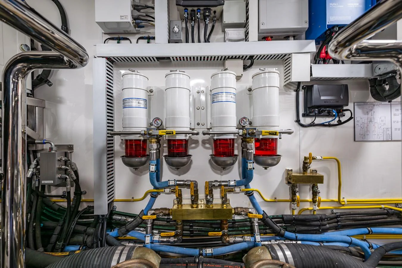The image showcases the yacht's engine room with a focus on the filtration system and various mechanical components. aboard ISLAND BREEZE Yacht for Sale