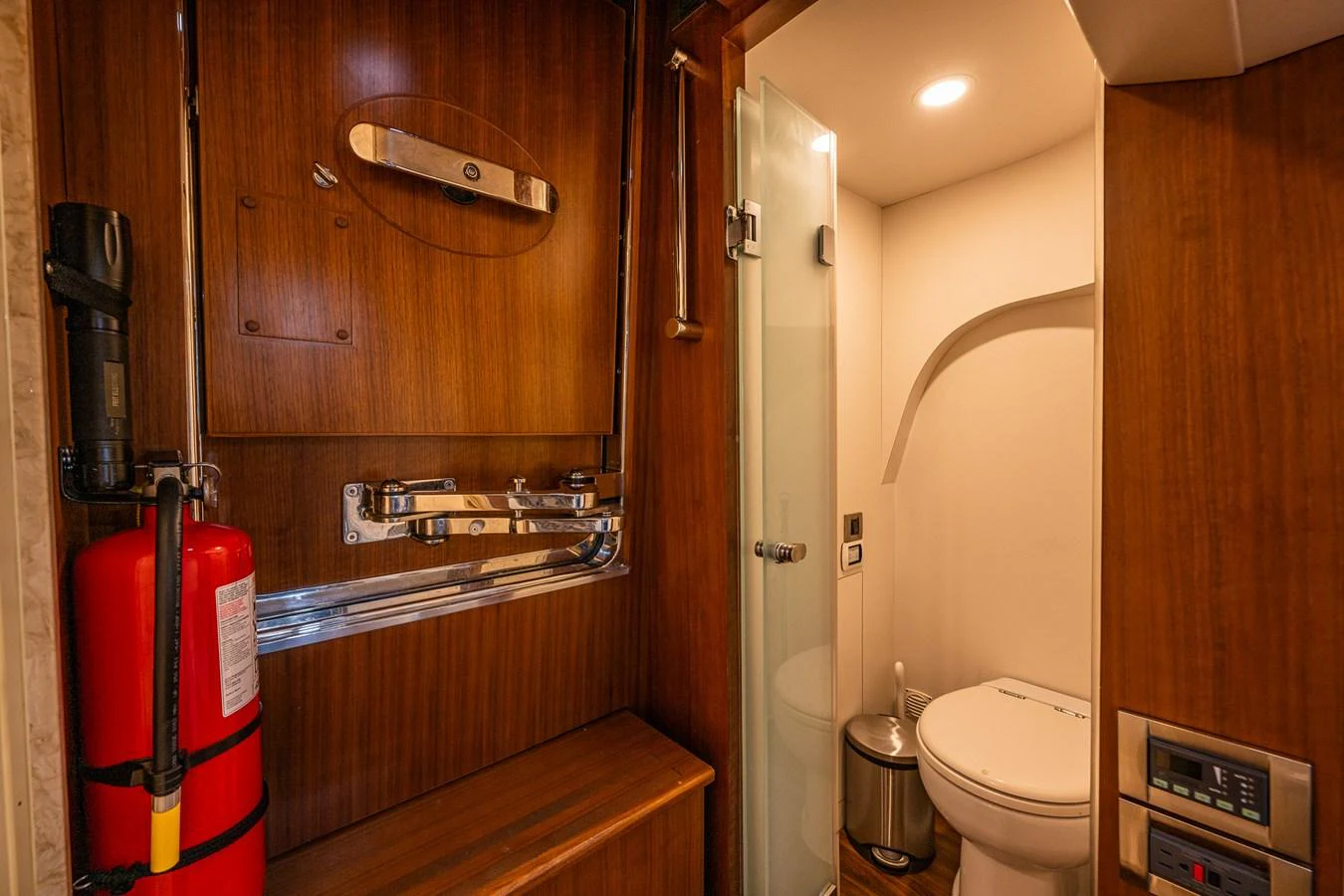 The yacht's head features elegant wood paneling and modern fixtures. aboard ISLAND BREEZE Yacht for Sale