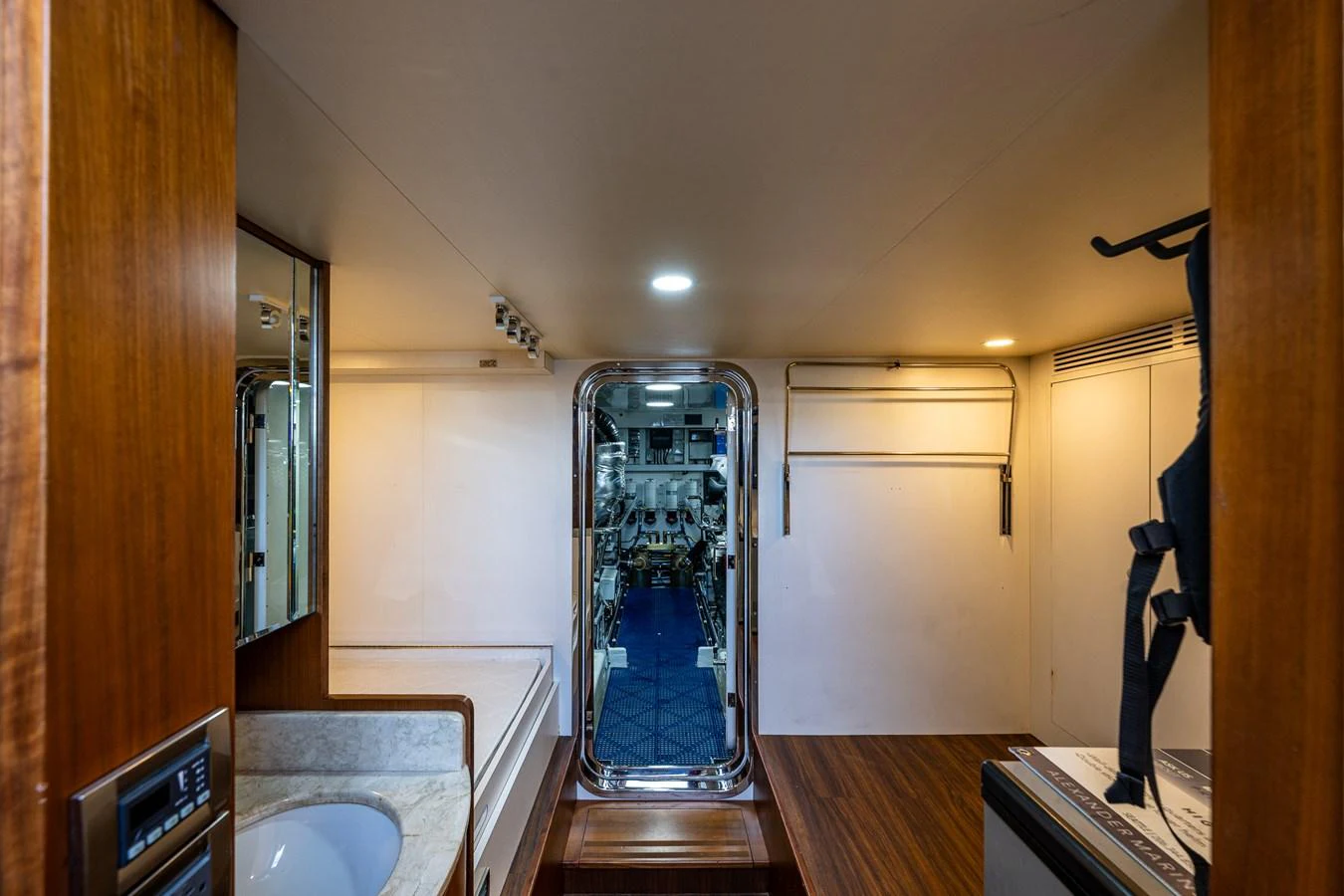 A well-lit interior passageway with wooden accents and a view into another room. aboard ISLAND BREEZE Yacht for Sale