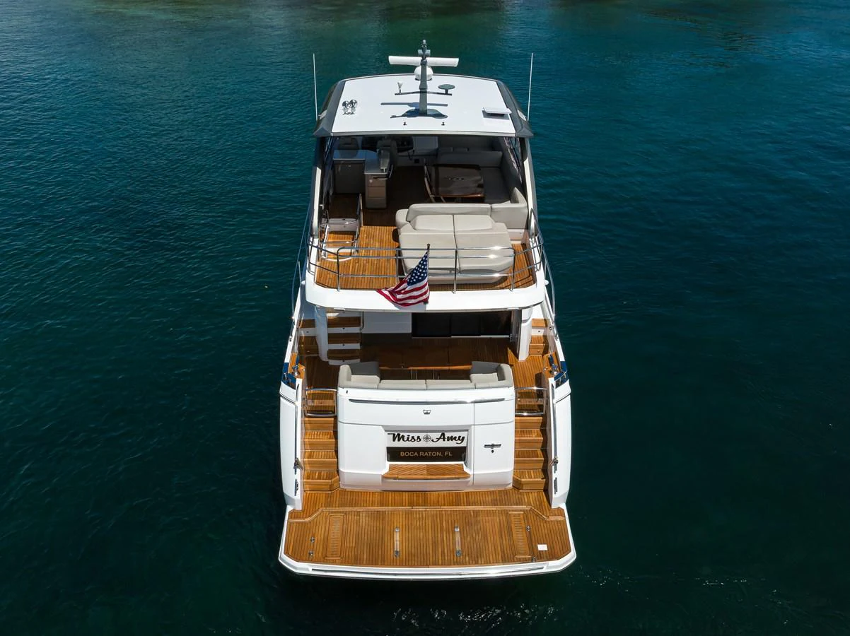 The yacht's aft deck features a spacious seating area and a swim platform, perfect for relaxation and water activities. aboard MISS AMY Yacht for Sale