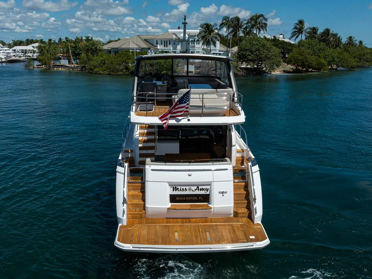 The yacht's aft deck showcases a spacious and inviting area with elegant wooden flooring, perfect for relaxation and entertaining. aboard MISS AMY Yacht for Sale