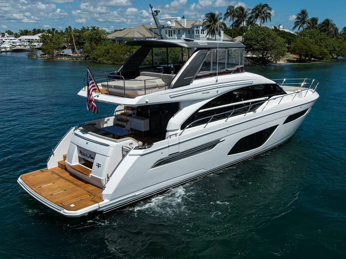 A sleek and modern yacht cruises through calm waters, showcasing its elegant design and spacious flybridge. aboard MISS AMY Yacht for Sale