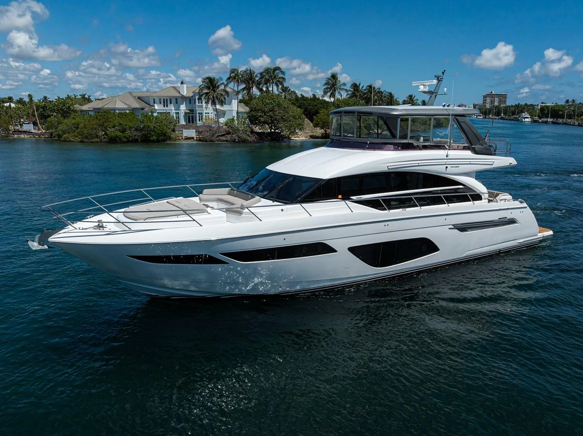 A sleek and modern yacht cruising on calm waters under a clear blue sky. aboard MISS AMY Yacht for Sale
