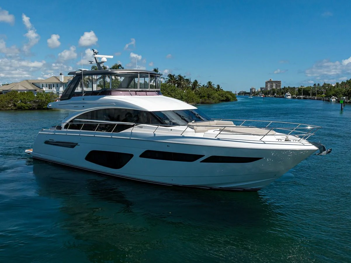 A sleek yacht cruises through serene waters under a clear blue sky. aboard MISS AMY Yacht for Sale
