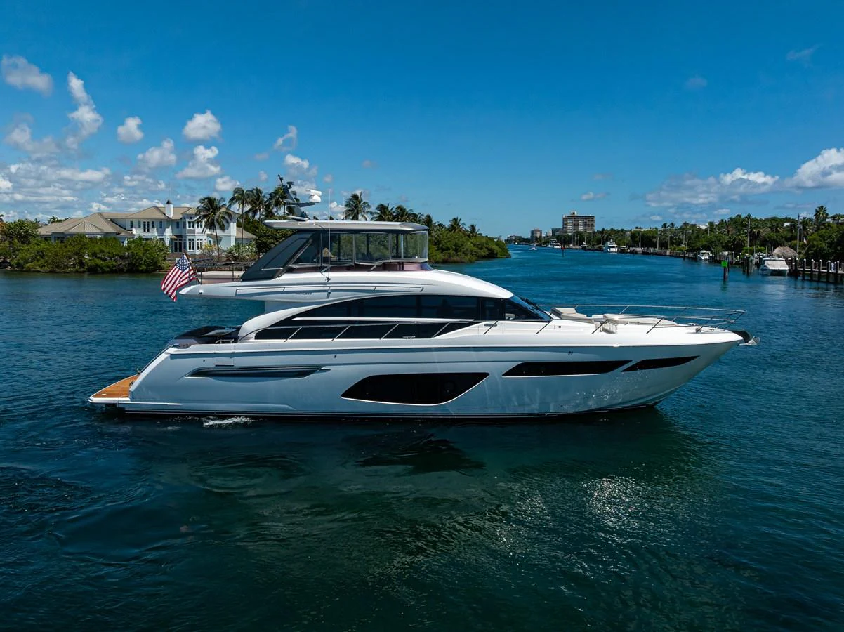 A sleek and modern yacht cruises gracefully on calm waters under a clear blue sky. aboard MISS AMY Yacht for Sale