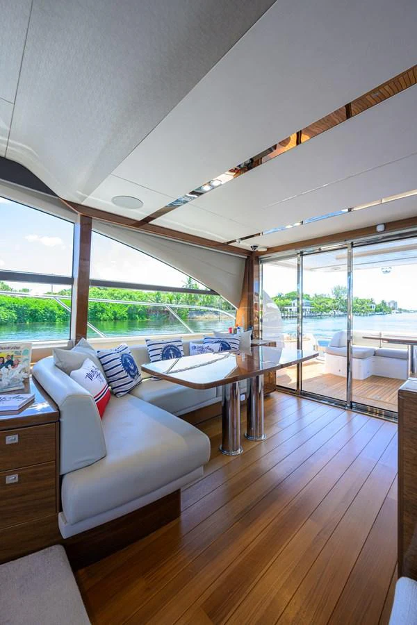 The salon offers a bright and inviting space with large windows and comfortable seating. aboard MISS AMY Yacht for Sale