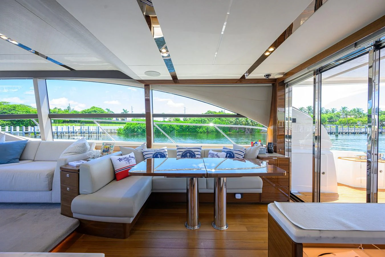 The salon features a spacious seating area with large windows providing scenic views. aboard MISS AMY Yacht for Sale