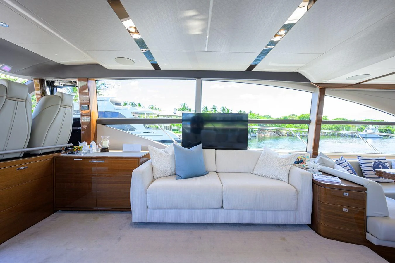 The salon features a comfortable seating area with large windows providing a scenic view. aboard MISS AMY Yacht for Sale