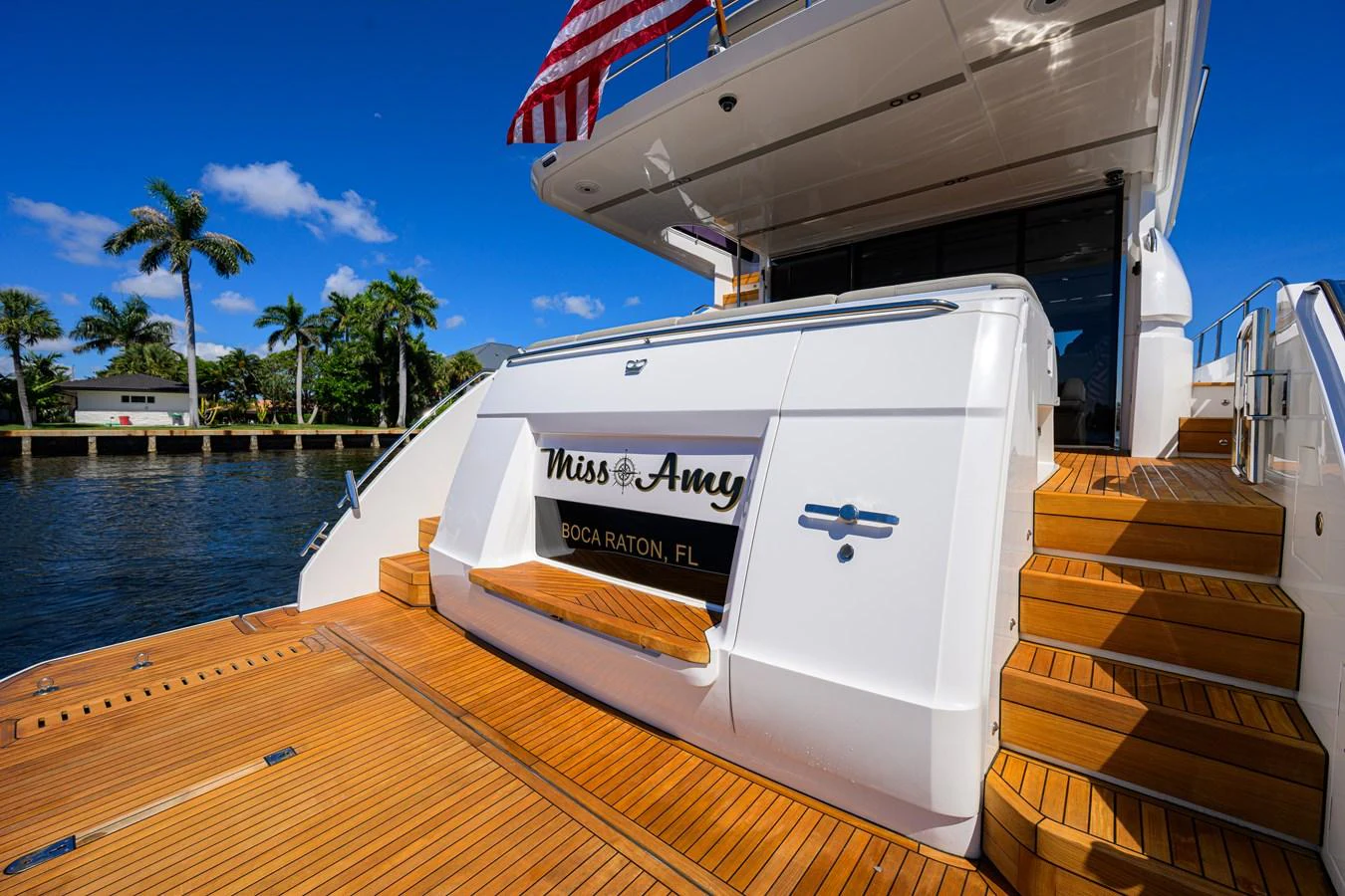 The aft deck features a spacious area with teak flooring and elegant steps leading to the upper deck. aboard MISS AMY Yacht for Sale