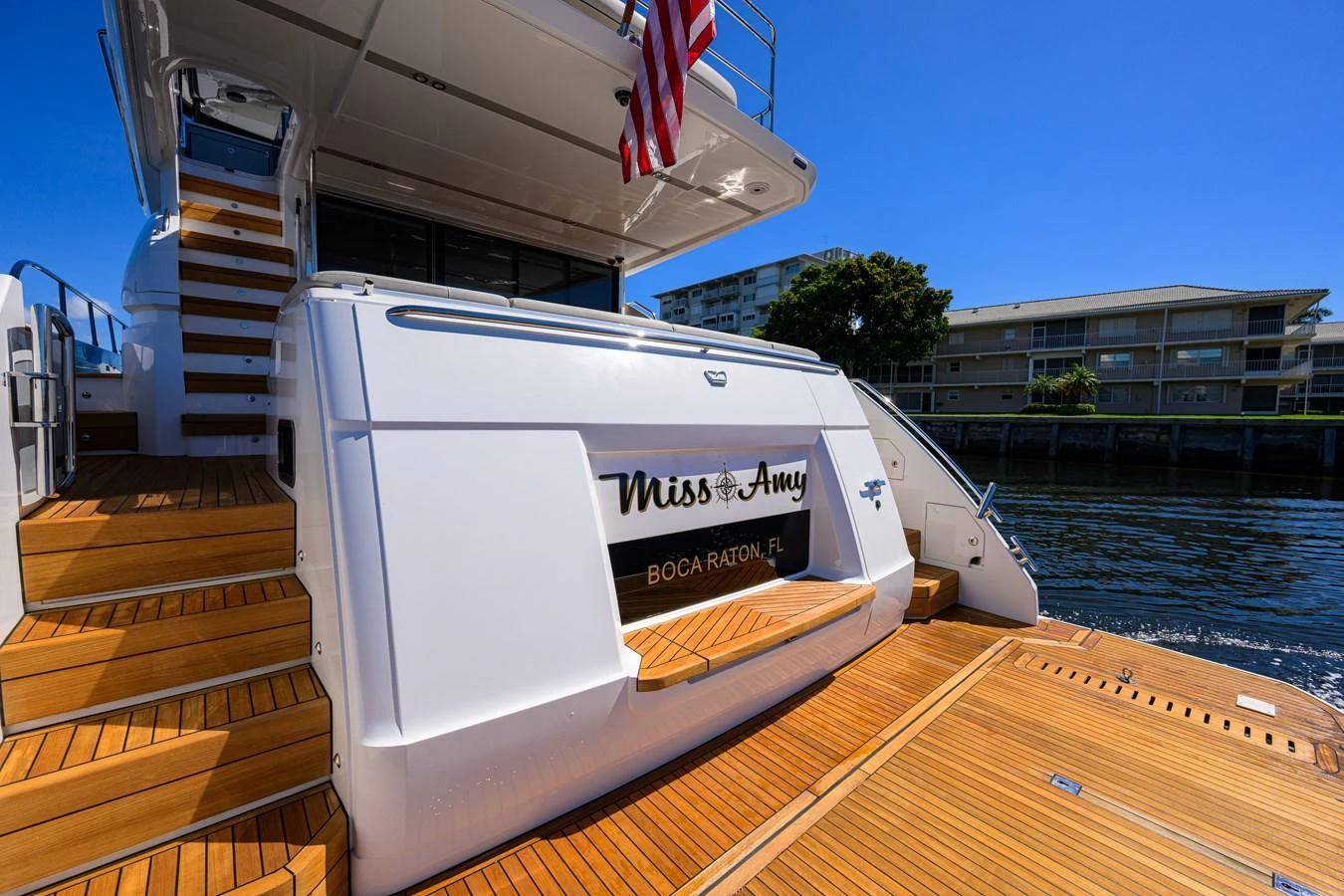 The yacht's aft deck features elegant teak flooring and a sleek design, perfect for outdoor relaxation. aboard MISS AMY Yacht for Sale