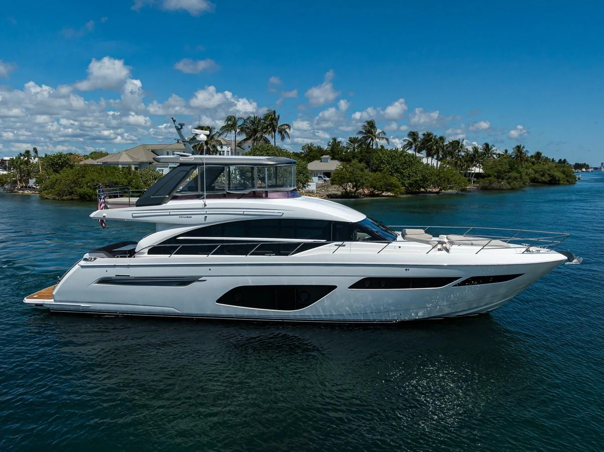A sleek yacht cruises through calm waters under a bright blue sky. aboard MISS AMY Yacht for Sale