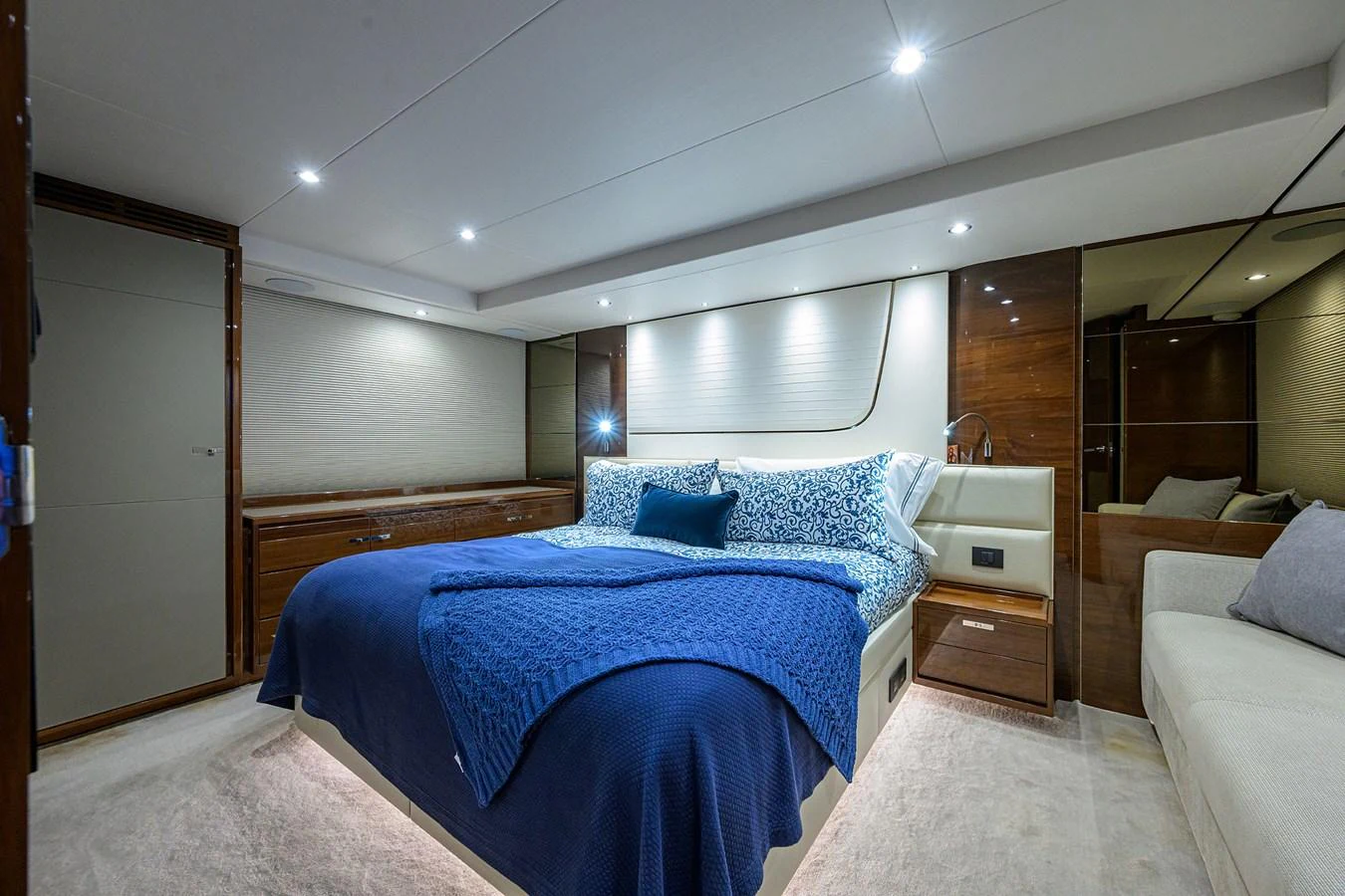 The stateroom features a plush bed with luxurious bedding and ambient lighting. aboard MISS AMY Yacht for Sale