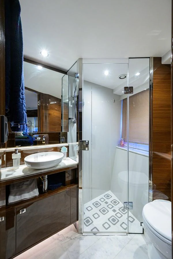 The yacht's bathroom features modern fixtures and a sleek design with a glass-enclosed shower. aboard MISS AMY Yacht for Sale