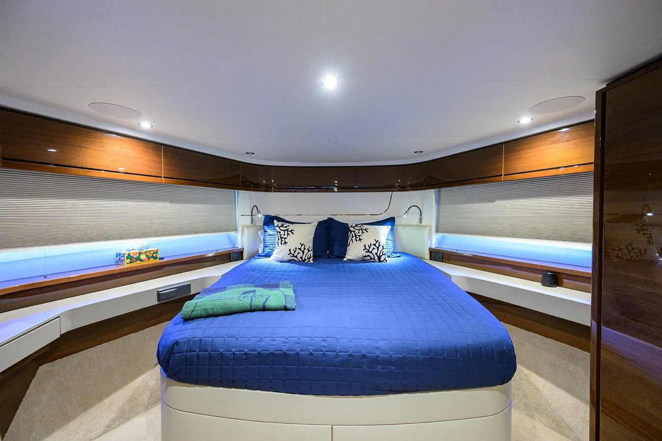 The master stateroom features a luxurious bed with elegant bedding and ambient lighting. aboard MISS AMY Yacht for Sale
