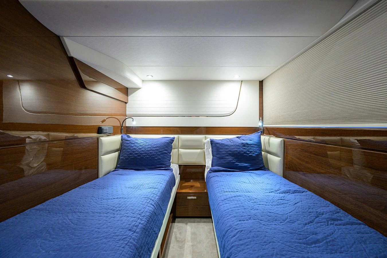 The twin stateroom features two comfortable single beds with elegant bedding and modern wooden finishes. aboard MISS AMY Yacht for Sale