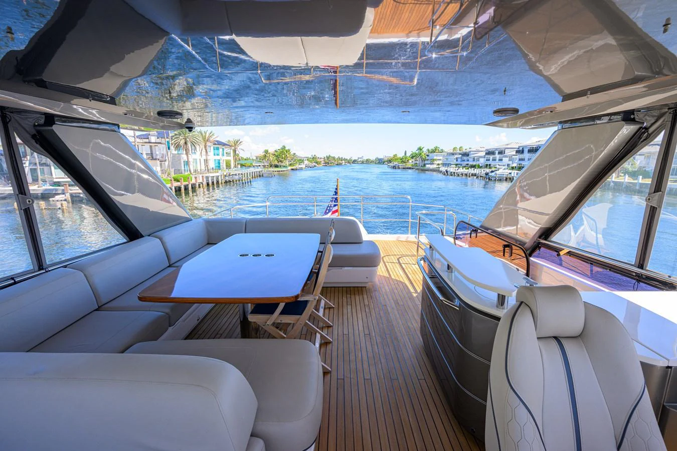 The aft deck offers a spacious seating area with a dining table and panoramic views of the water. aboard MISS AMY Yacht for Sale