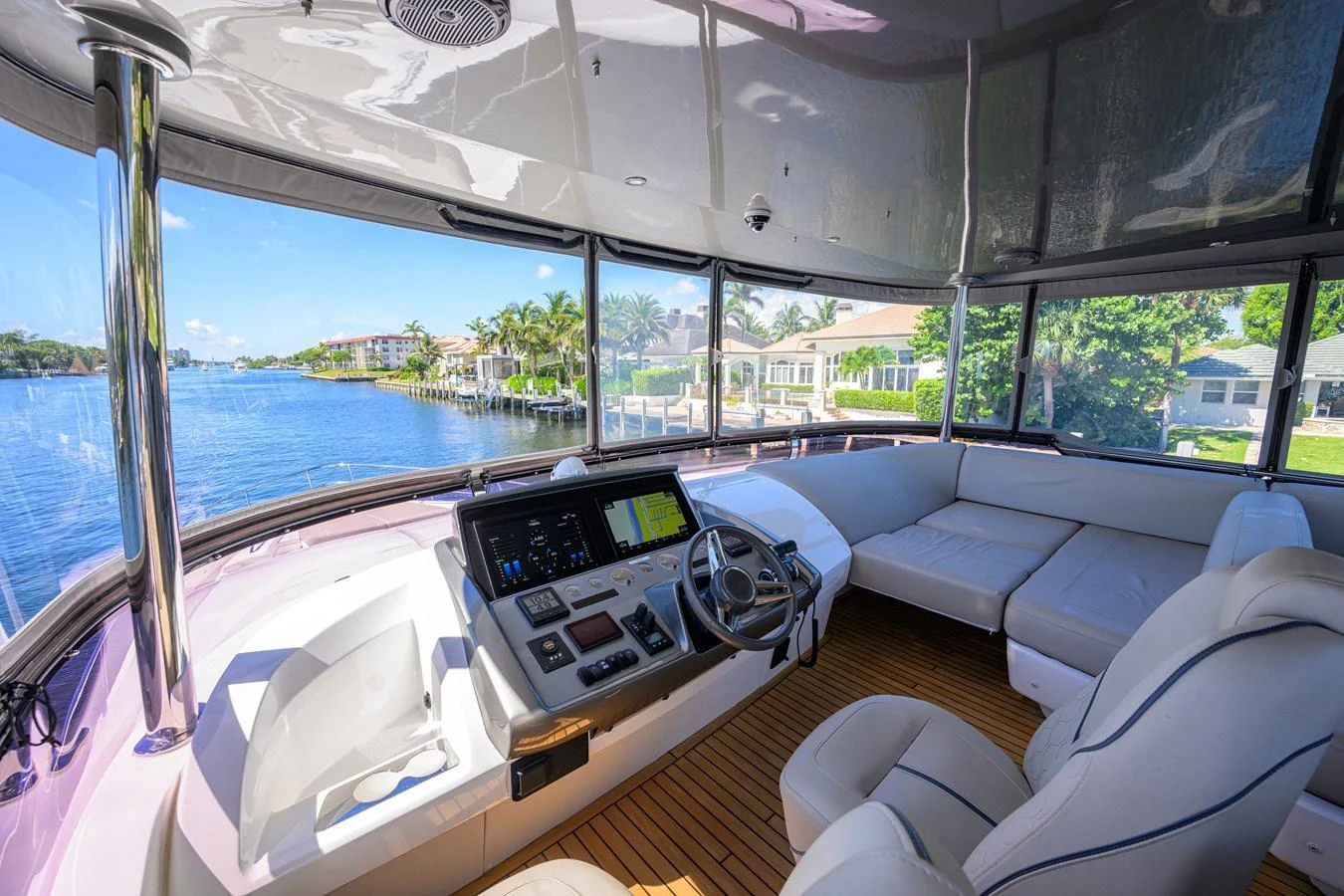 The helm station offers a panoramic view with plush seating and advanced navigation equipment. aboard MISS AMY Yacht for Sale