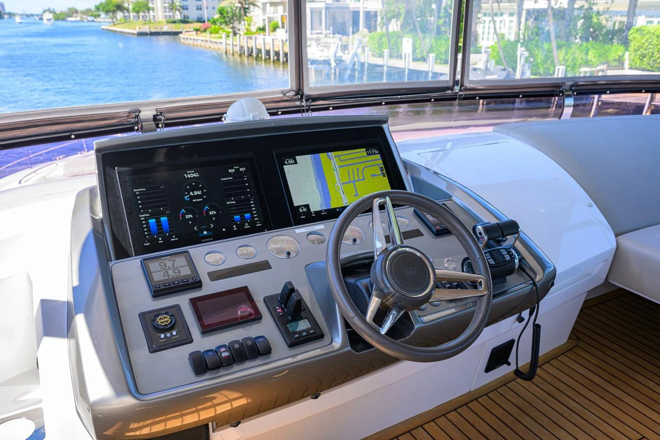 The helm station offers advanced navigation technology with a scenic view of the waterway. aboard MISS AMY Yacht for Sale