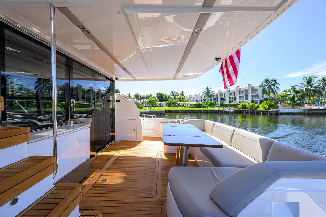 The aft deck offers a spacious and inviting area for relaxation and dining with a scenic waterfront view. aboard MISS AMY Yacht for Sale