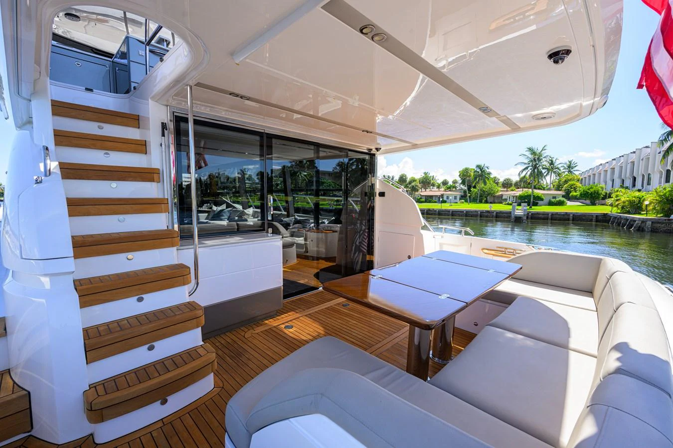 The aft deck features a comfortable seating area with a dining table, perfect for alfresco dining and relaxation. aboard MISS AMY Yacht for Sale