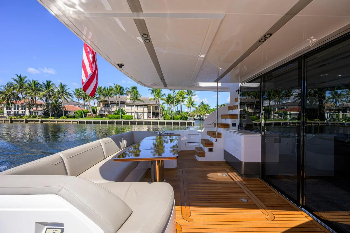The aft deck features a comfortable seating area with a dining table, perfect for enjoying meals with a view of the water. aboard MISS AMY Yacht for Sale