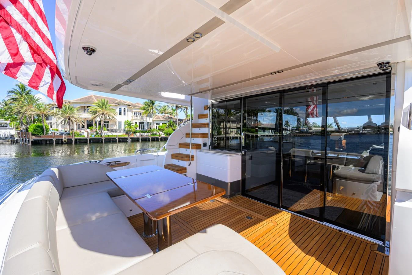 The yacht's aft deck features a comfortable seating area with a dining table, perfect for alfresco dining. aboard MISS AMY Yacht for Sale