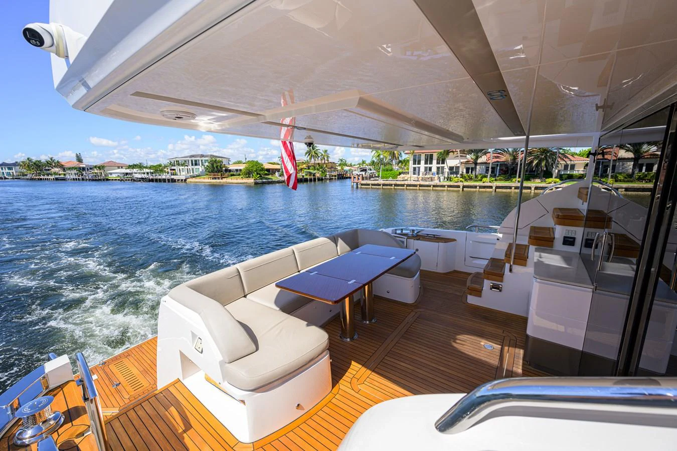 The yacht's aft deck features a comfortable seating area with a table, perfect for outdoor dining and relaxation. aboard MISS AMY Yacht for Sale