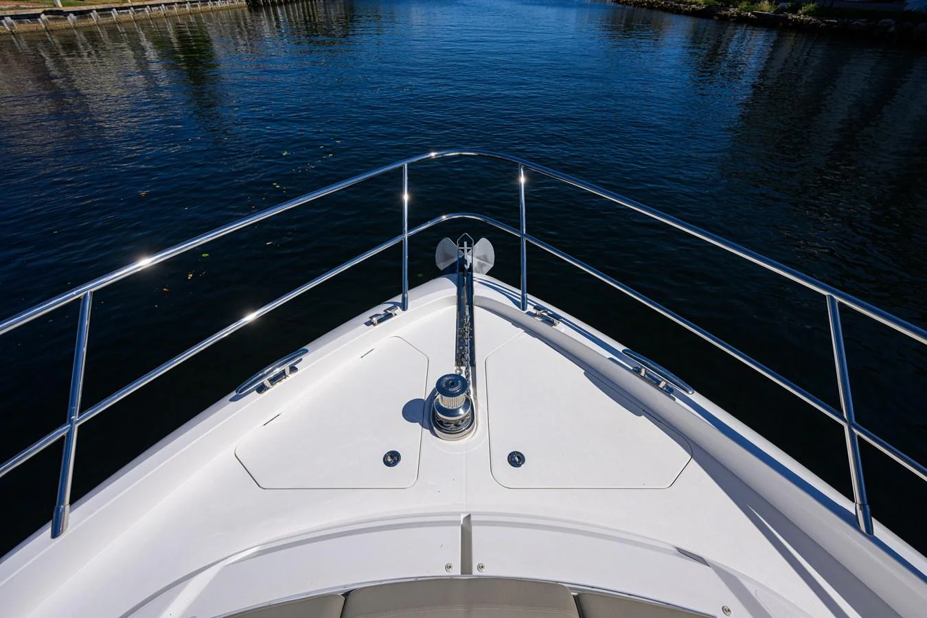 The bow of the yacht features a sleek design with polished railings and a central anchor mechanism. aboard MISS AMY Yacht for Sale