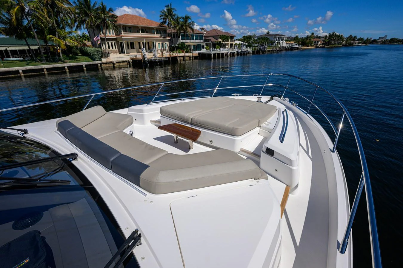 The yacht's foredeck offers a spacious sunbathing area with plush cushions and a small table, perfect for relaxation. aboard MISS AMY Yacht for Sale