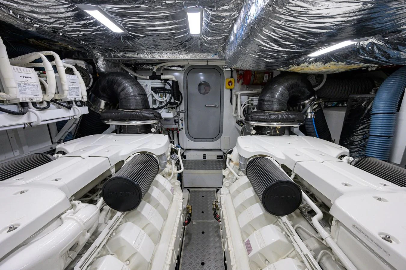 The image showcases the yacht's pristine engine room with dual engines and well-organized equipment. aboard MISS AMY Yacht for Sale