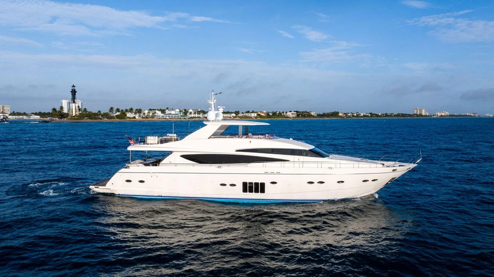 A sleek and modern yacht cruising on the open water under a clear blue sky. aboard OASIS Yacht for Sale