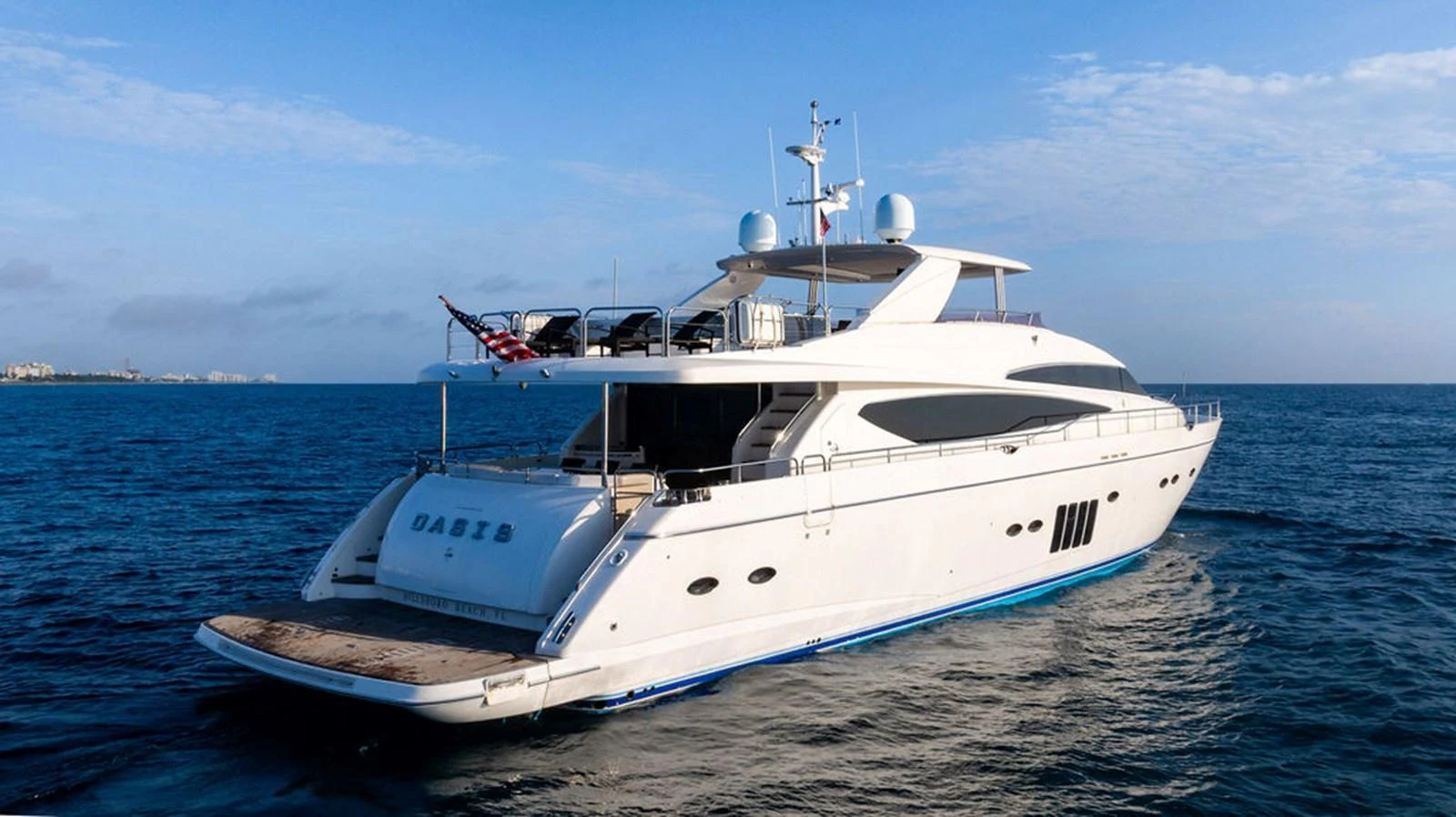 A sleek and modern yacht cruising on calm blue waters under a clear sky. aboard OASIS Yacht for Sale