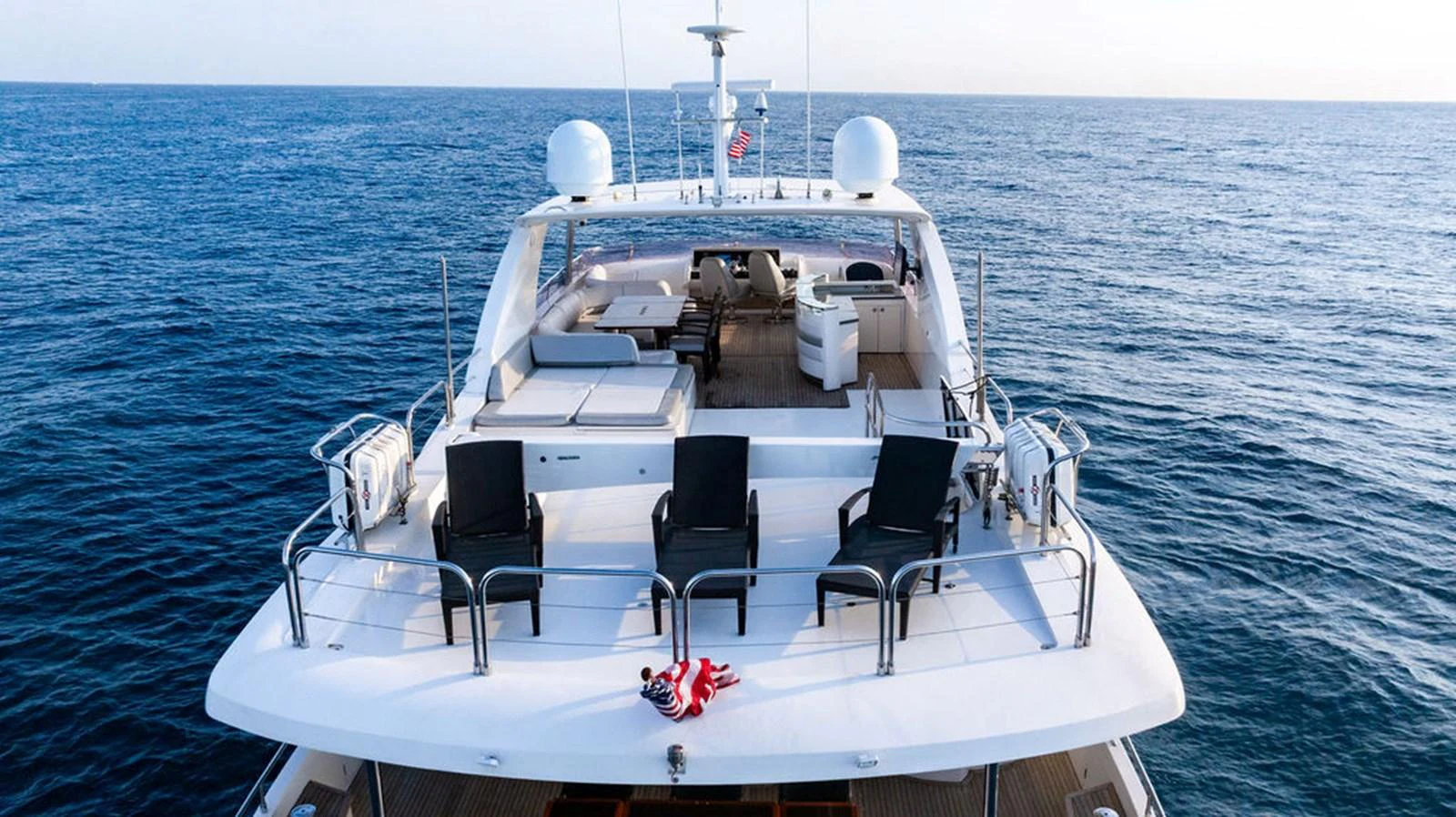 The yacht's aft deck features a spacious seating area with a stunning view of the open sea. aboard OASIS Yacht for Sale