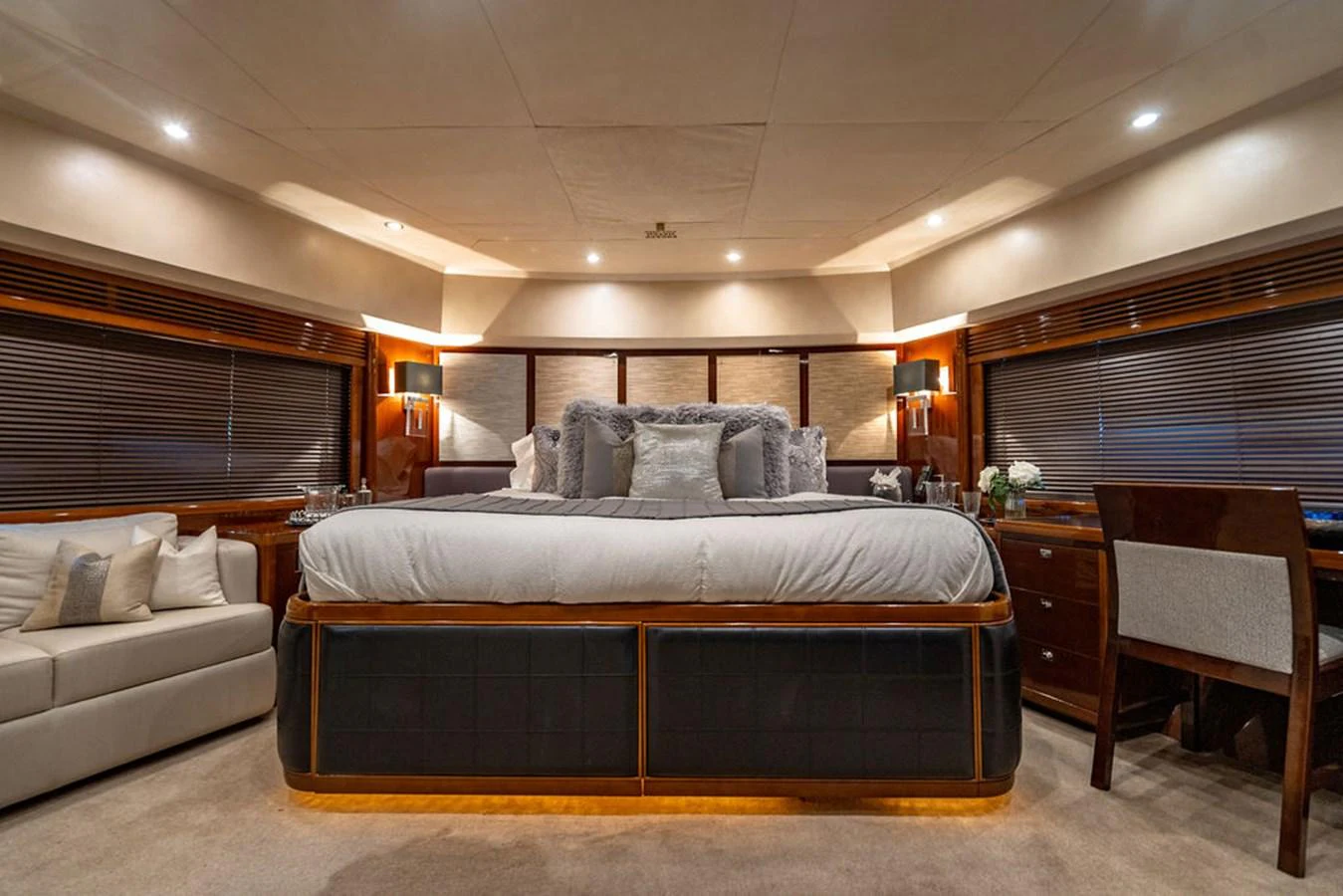 The master stateroom features a luxurious bed with elegant lighting and ample space for relaxation. aboard OASIS Yacht for Sale