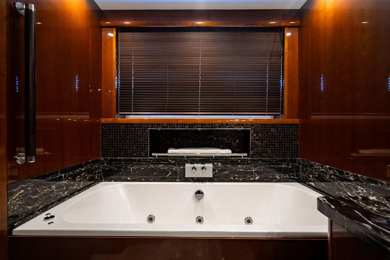 The yacht's bathroom features a luxurious bathtub with elegant marble accents. aboard OASIS Yacht for Sale