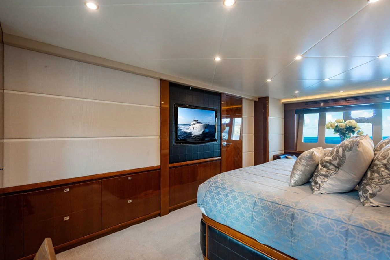 The master stateroom features a luxurious bed, elegant decor, and a flat-screen TV for ultimate comfort. aboard OASIS Yacht for Sale